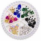 Multicolour heart rhinestone and crown nail art charms in compartment wheel on white background
